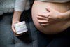 Pregnant model with basq Stretch mark butter in her hand