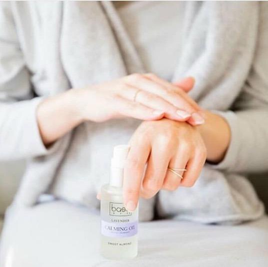 pregnant woman using lavender calming oil on hands